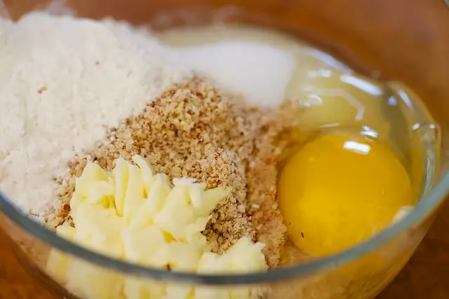 Add the ground almond, flour, butter, brown sugar and egg into a medium bowl. 