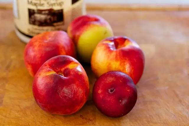 When the dough is almost doubled, start to prepare the peaches. 