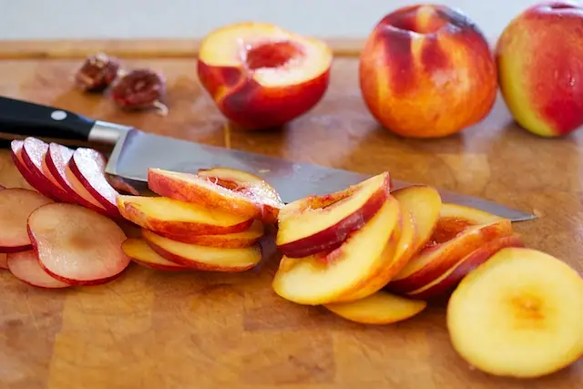 Half, core and slice the peaches or nectarines and plums into about ¼-inch thick slices. Set aside. 