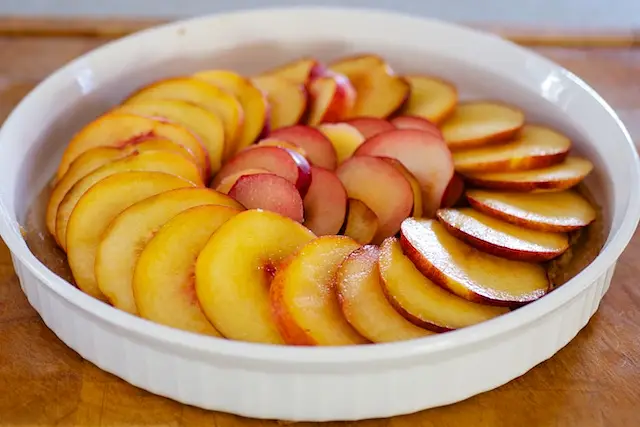 Lay the sliced peaches or nectarines and plums at a neat pattern over the almond topping. 