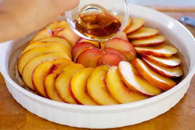 Drizzle the maple syrup over the fruits.