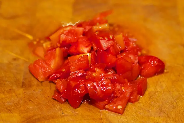 Dice the tomatoes.