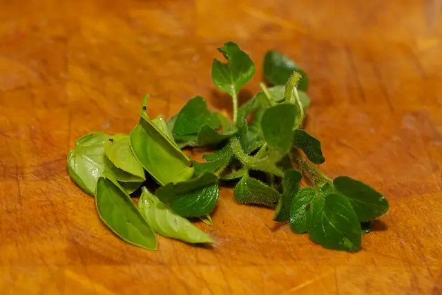 A few fresh basil and oregano leaves. Finely chop them.