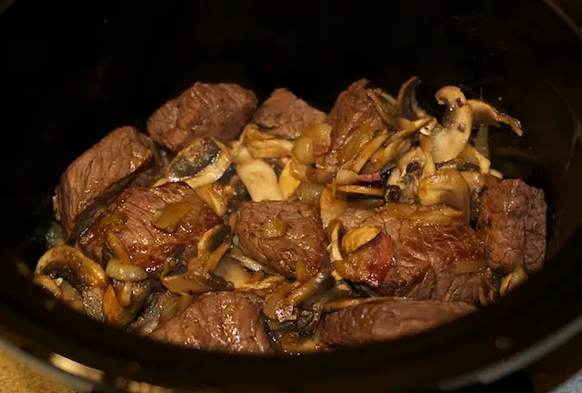 Pour reserved marinade and beef stock over all. 