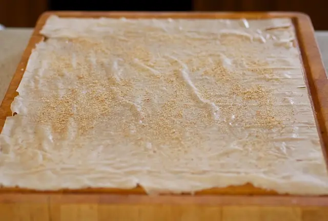 Place 1 phyllo sheet on a large cutting board or work surface