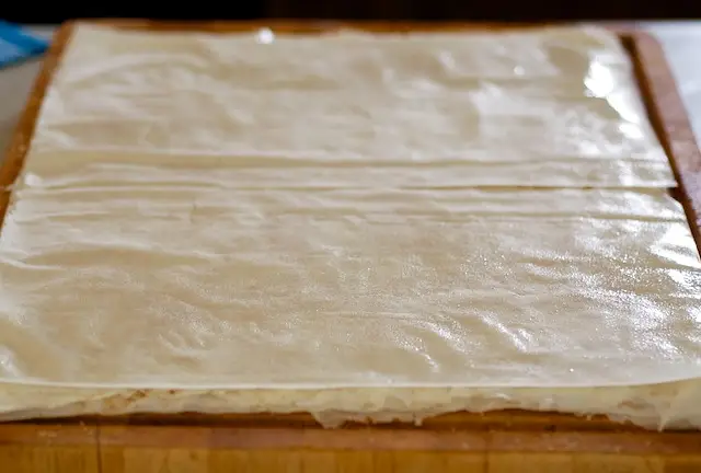 Repeat layers 3 times, top with 1 phyllo sheet. 