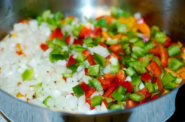 add the garlic, onions and green and red bell peppers,
