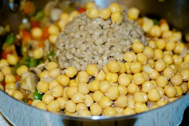 Add the garbanzo beans, barley, 