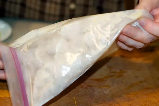 Shake a few chicken pieces in the bag at a time, coating well. 