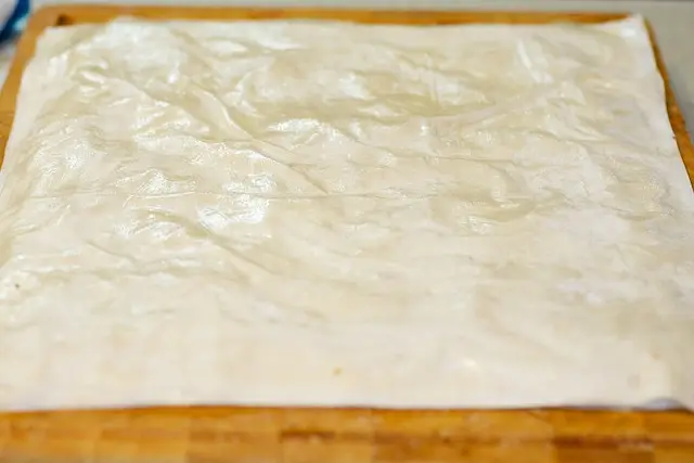 Layer with the 6 remaining phyllo sheets and butter.
