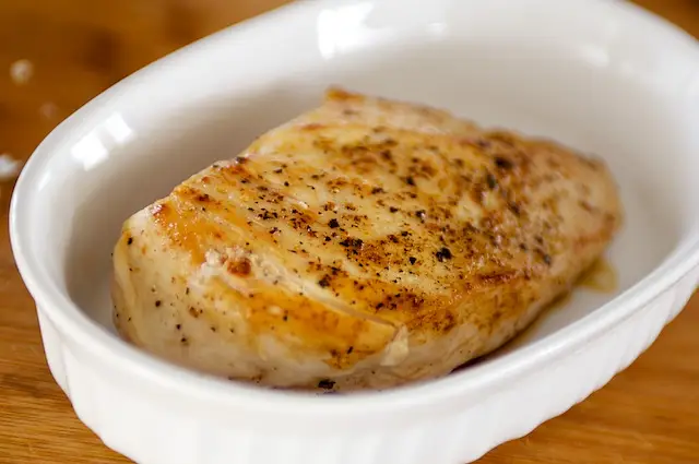 Remove the chicken breasts and arrange in a baking dish in a single layer. 