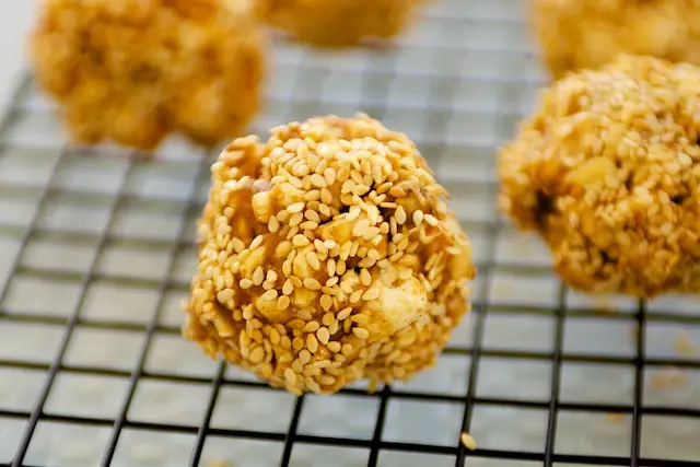 Double Peanuts & Honey Christmas Popcorn Balls with Sesame Coating