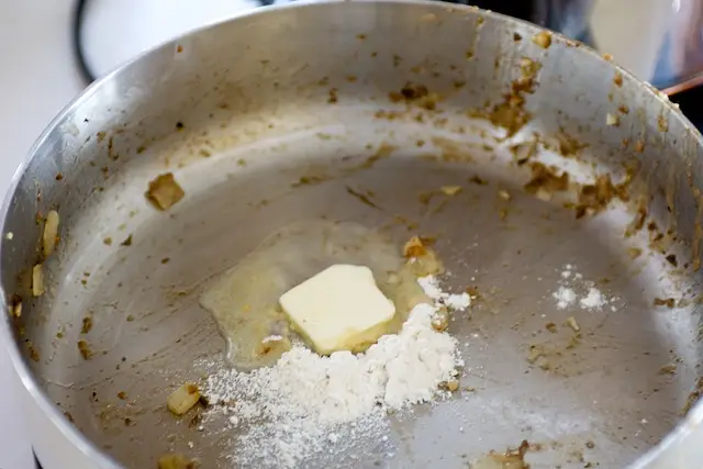 Add 2 tablespoons of butter to pan drippings and blend in the remaining flour.