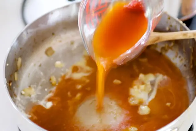 Mix the tomato paste with the beef stock and add to the pan.    