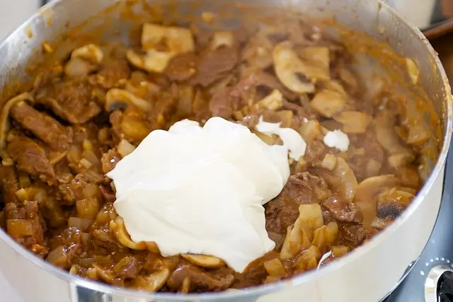 Stir in sour cream; cook,
