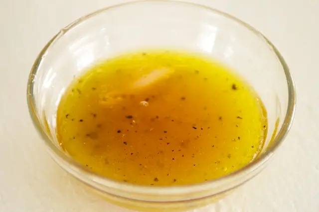In a bowl, whisk together the vinegar, maple syrup and olive oil until smooth. 