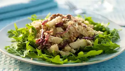 Quinoa and Arugula Salad with Pears, Walnuts, Dried Fruits, and Jack Cheese