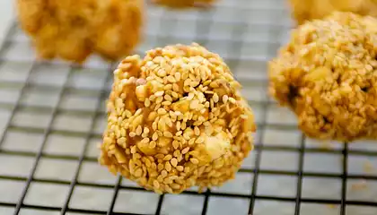 Double Peanuts and Honey Christmas Popcorn Balls with Sesame Coating