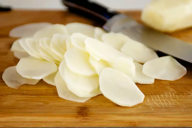 Next peel and thinly slice the potatoes.