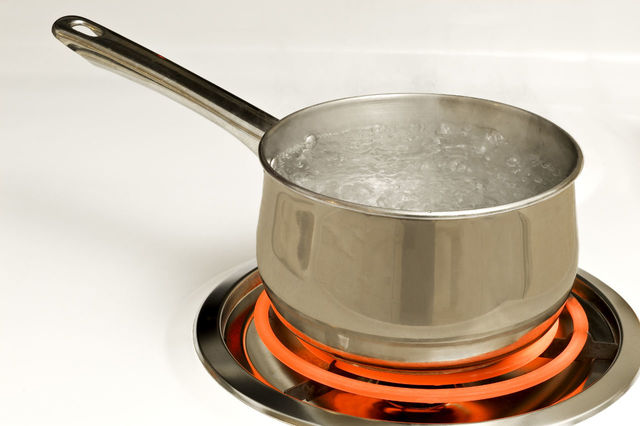 Boiling water in a pot on a red hot burner