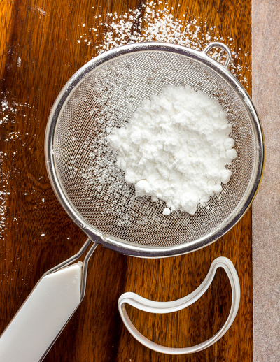 powdered icing sugar in a sieve